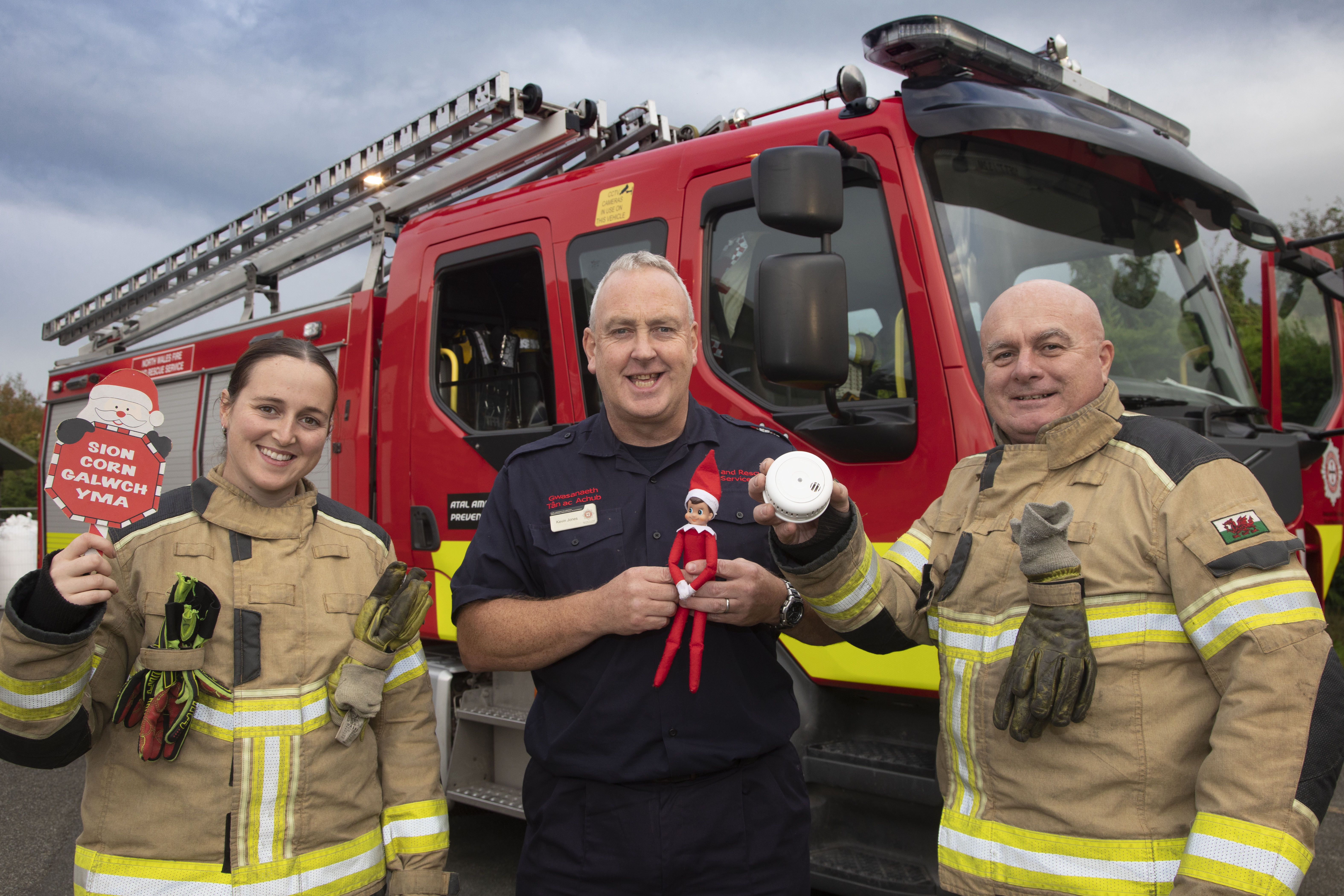 Head of Prevention Kevin Jones alongside firefighters with Christmas decorations